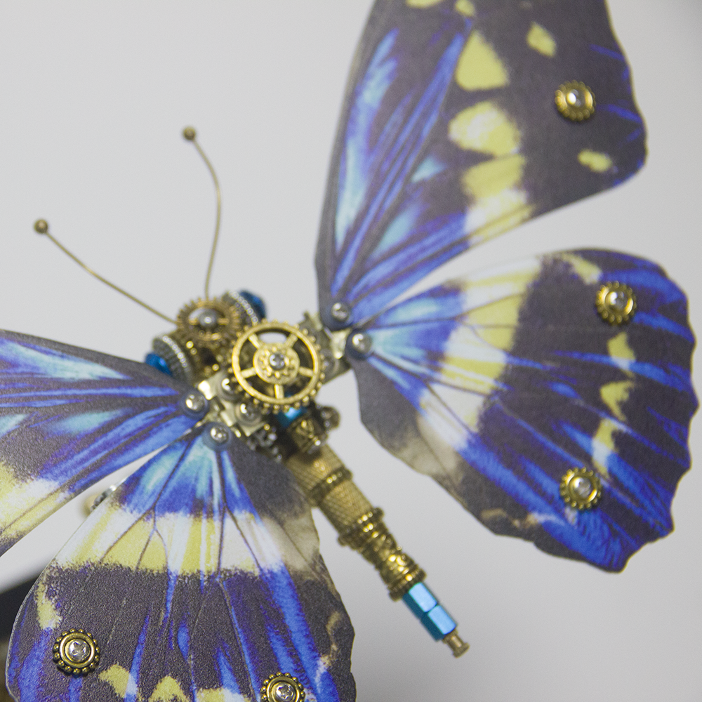 Rompecabezas mecánico de metal Steampunk con diseño de mariposa y caja de música.